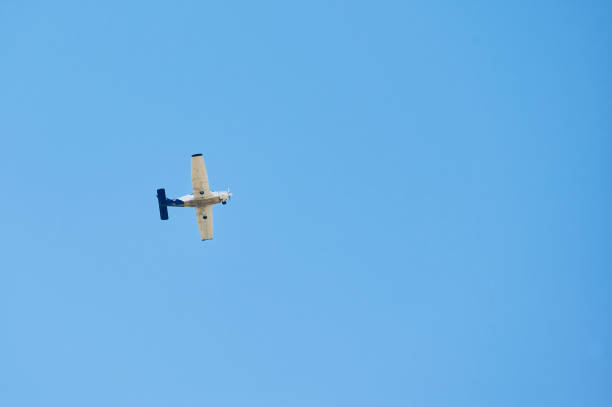 istock Small recreational plane, ideal for flight practice flying over a blue sky on a clear day 1392388979