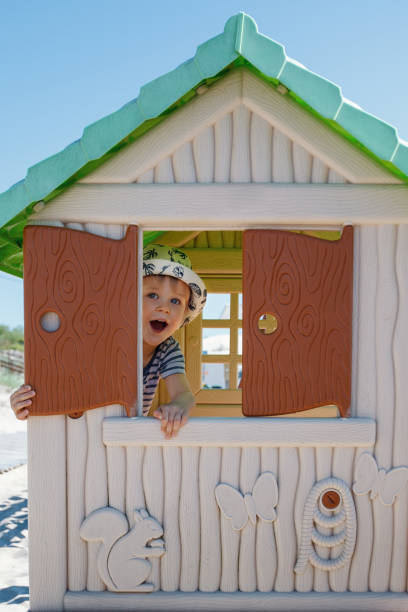 istock The boy was hiding in a small toy house. 1392389769