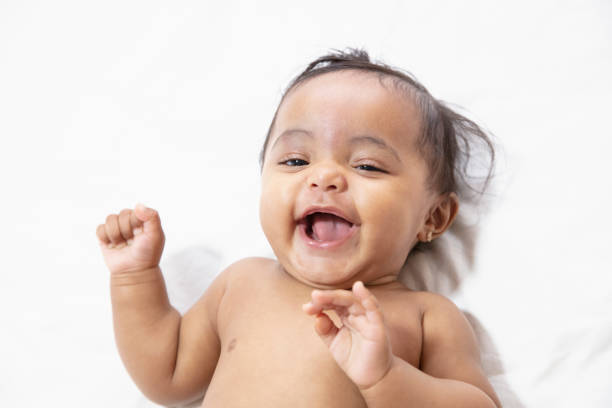 baby smiling in white background stock photo