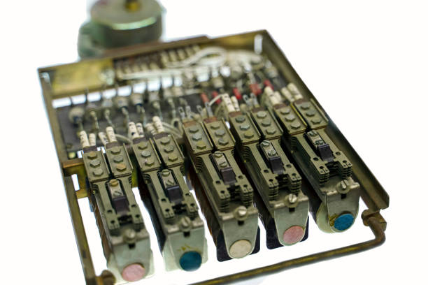 Isolate. Old analog switching relay for electrical signals with color round signs.