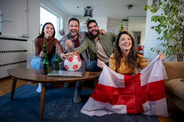 English fans are watching a football  match on TV stock photo