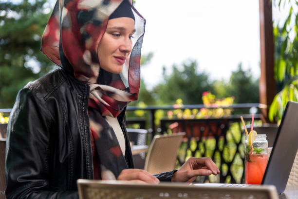 istock Muslim woman freelancer working at cafe. 1392393906