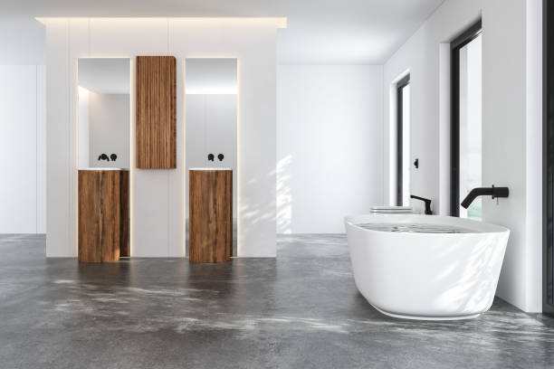 istock Modern bathroom with white bathtub and two sinks with square mirrors. 1392394083