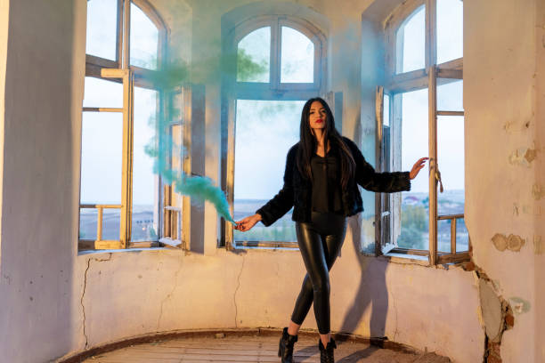 Young woman holding a smoke bomb
