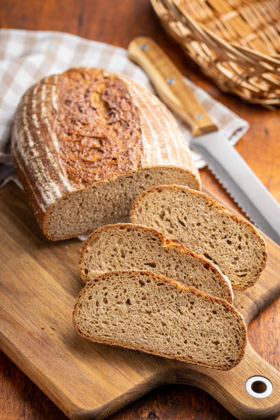 istock Sliced loaf of bread on cutting board. 1392395276