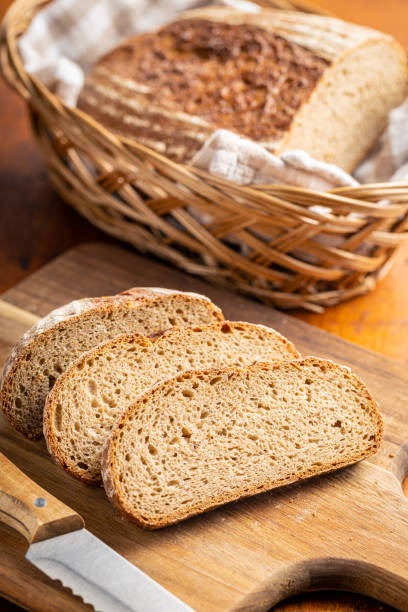 istock Sliced loaf of bread on cutting board. 1392395277