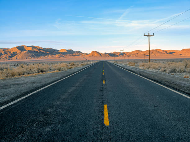 Diminishing perspective of Highway 50 in Northern Nevada Diminishing perspective of Highway 50, Known as the Loneliest Road in America, located in Northern Nevada empty road stock pictures, royalty-free photos & images