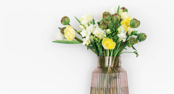 istock Glass vase with flowers isolated on white background. 1392401041