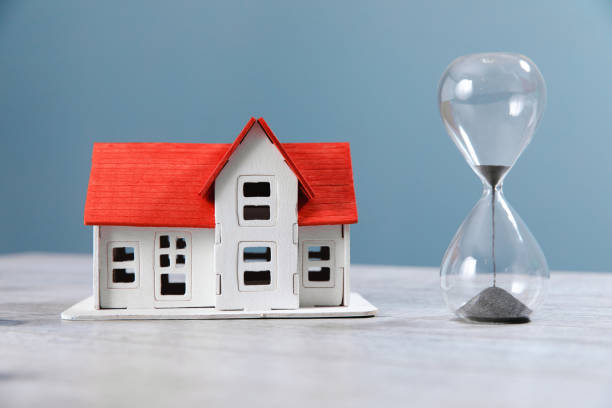 istock house model and hourglass on table 1392401201