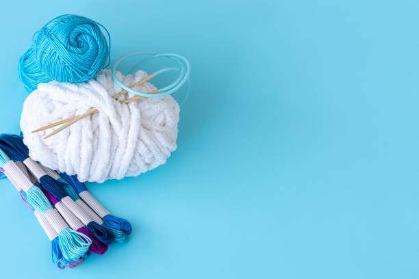 istock Threads of different colors on a blue background. 1392401894