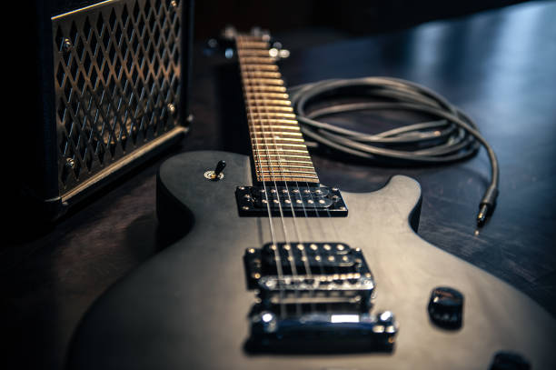 istock Close-up, black electric guitar on a dark background. 1392402603
