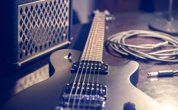 istock Close-up, black electric guitar on a dark background. 1392402605