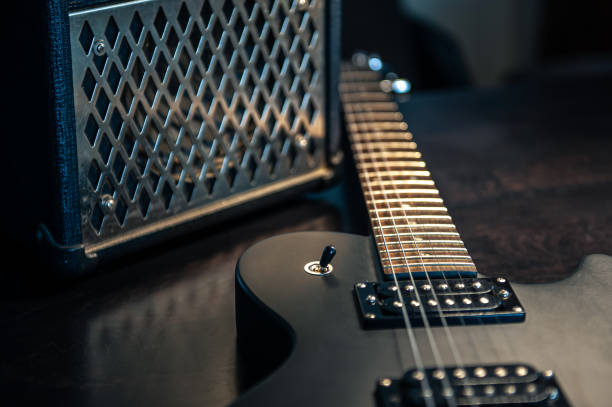 istock Close-up, black electric guitar on a dark background. 1392402614
