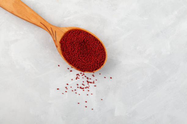 istock Organic Beetroot couscous in wooden spoon on light grey background, close-up. Top view, copy space 1392404702