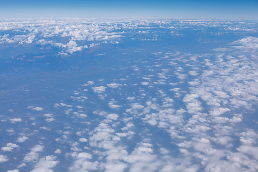 Above the altocumulus clouds . Flight over the earth