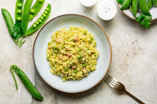 Italian, Venetian rice and pea. Risi e bisi.  Spring, dish made with Vialone nano rice, spring green peas and bacon. Horizontal image, copy space.