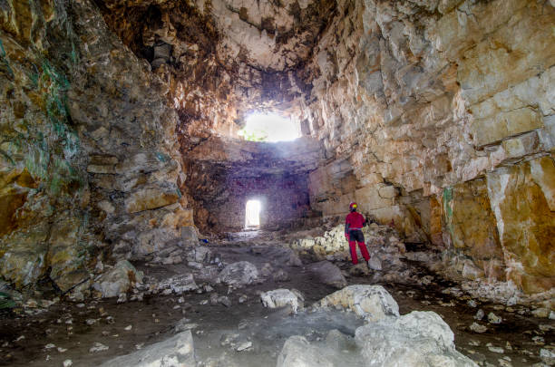 Sant'Angelo cave of Ostuni Ostuni, Puglia, Italy - September 12, 2020: The cave is located on the outskirts of Ostuni and can be walked horizontally with the use of only basic speleology equipment: suit and helmet with front light for caving. geologist stock pictures, royalty-free photos & images