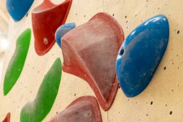 istock Stone hooks or grips on the artificial climbing wall in bouldering gym 1392415581