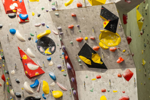 istock Artificial rock climbing wall with various colored grips 1392416175