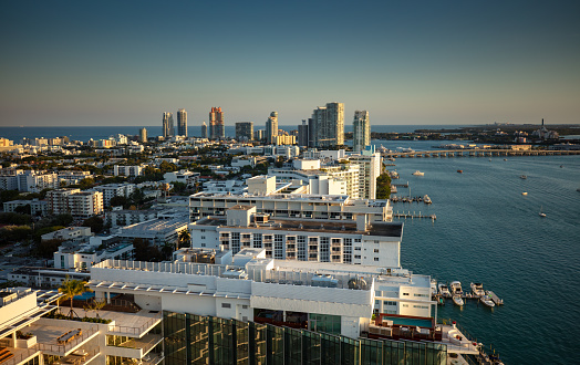 High angle view of the west coast of Miami Beach at sunset, looking over condo buildings towards the southern point of the island and the Port of Miami-Dade. This image is part of a series of views taken at different times of day from the same location; a time lapse is also available