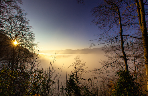 View of fog filled valley in the Swiss Alps at sunset. This image is part of a series of views taken at different times of day from the same location; a time lapse is also available.