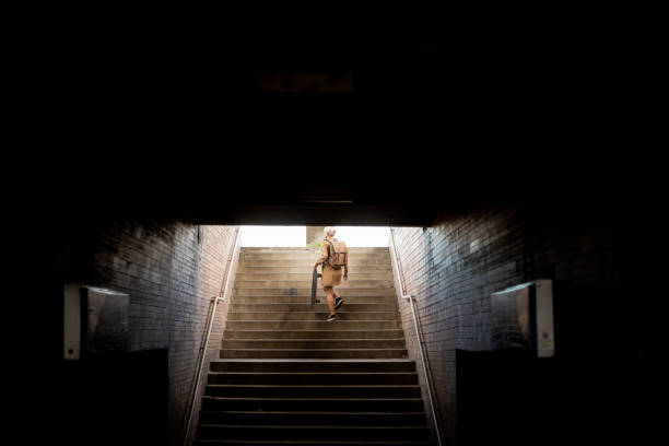 istock Female commuter on a way to job from subway 1392417714