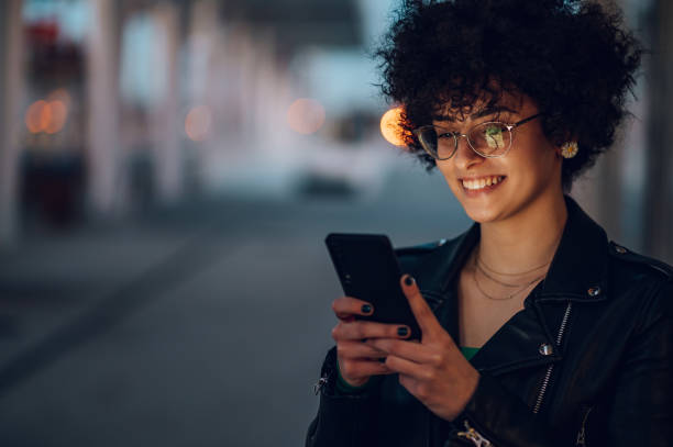 istock Woman waiting on a train station platform and using smartphone 1392419488
