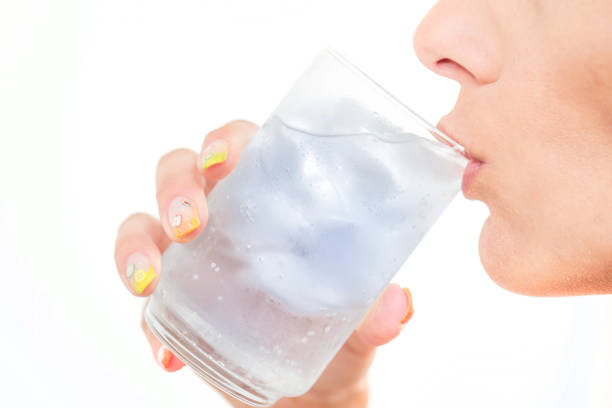 Drinking ice cold glass of water stock photo