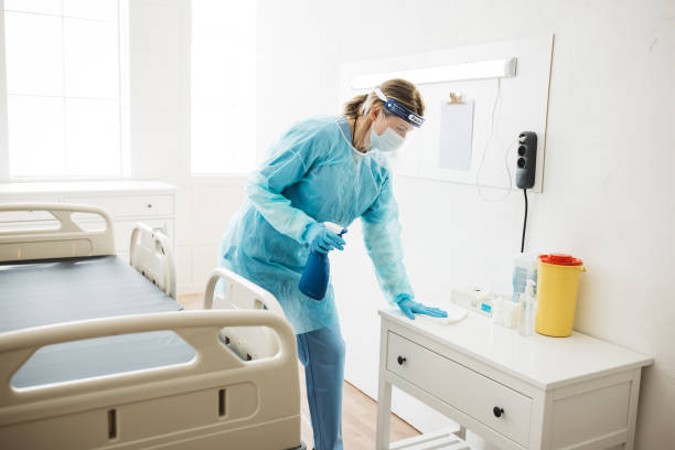 Nurse cleaning hospital ward. stock photo