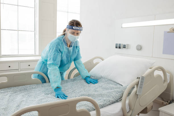 istock Nurse cleaning hospital ward. 1392421608