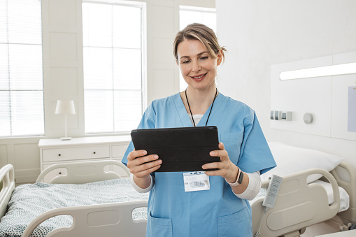 Portrait of female nurse using tablet at hospital.