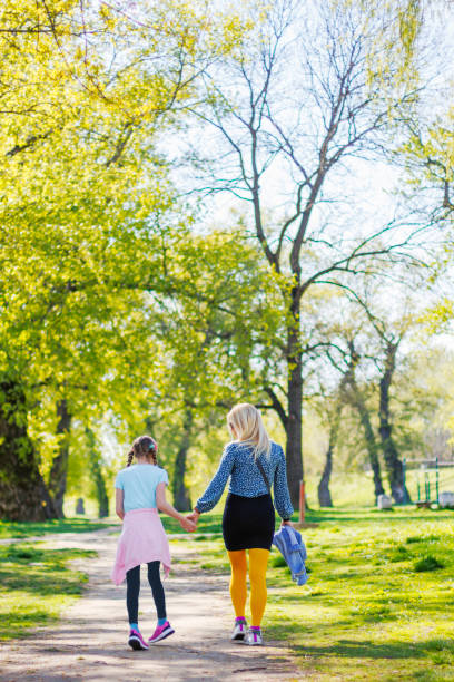 istock Walking with daughter in the park 1392421730