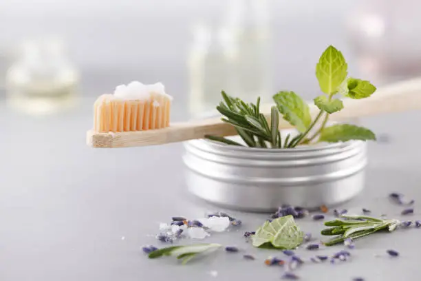 Bamboo toothbrush with natural salt toothpaste and herbs.