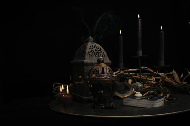 istock Talking spiritual board with black candles and old key. Wicca, esoteric and occult background with vintage magic objects for mystic rituals. Halloween and gothic concept. 1392425133