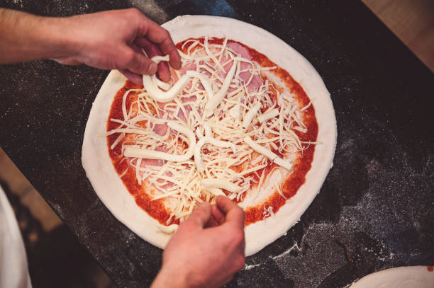 istock Pizza topped with tomato sauce, ham and cheese 1392429015