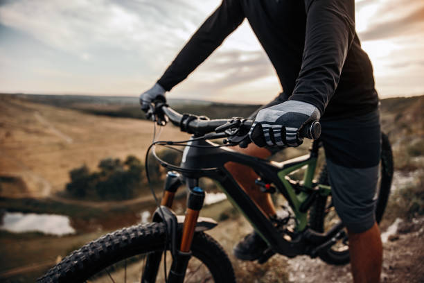 istock Crop cyclist riding bike in mountains 1392429023