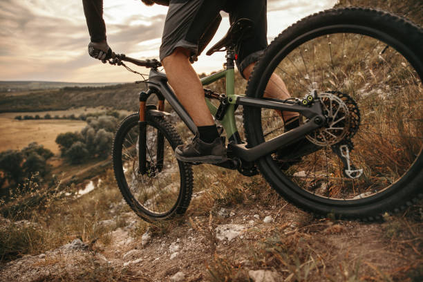 istock Crop man riding mountain bike 1392429052