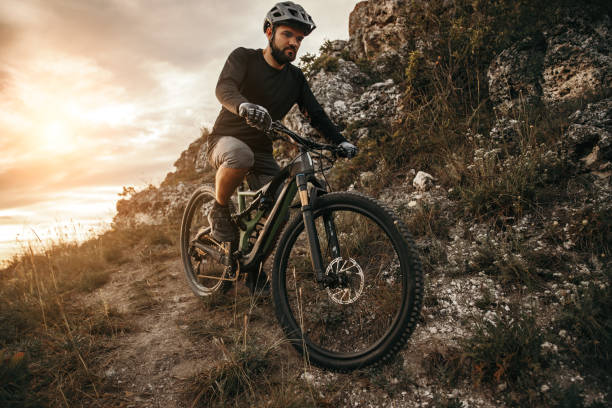 istock Bearded man riding bicycle in mountains 1392429069