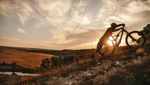 istock Cyclist with mountain bike at sunset 1392429073