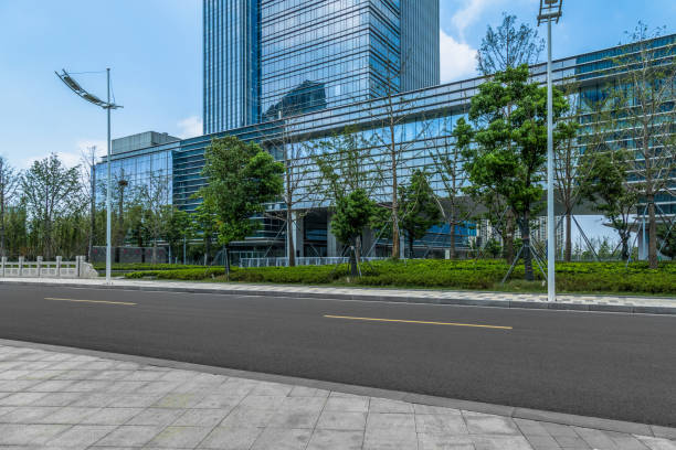istock empty asphalt road near glass office building 1392439597