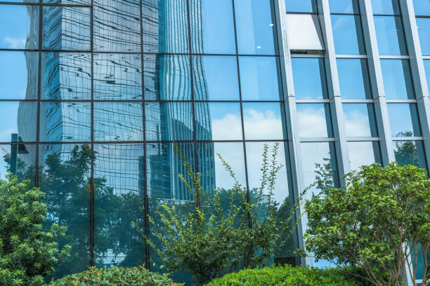 istock modern office building with green trees 1392439599
