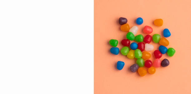 istock Assortment of small colored candies - Text space 1392440319