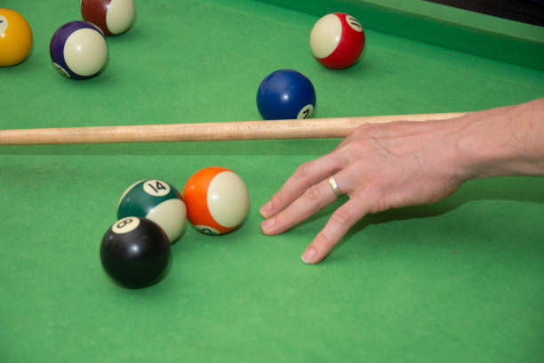 istock Hand with cue aiming on billiard ball at table 1392441468