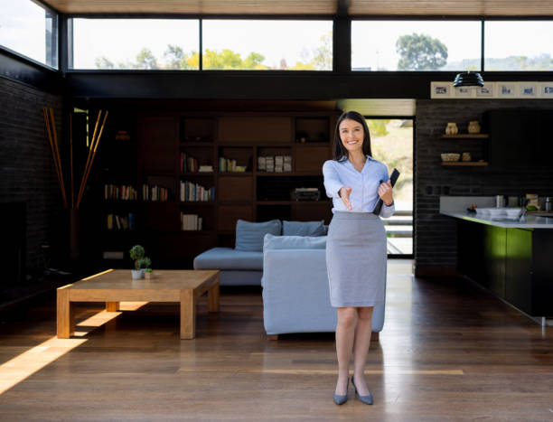 istock Real estate agent with hand extended for a handshake 1392442592