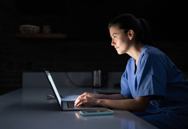 istock Doctor working late at home on her laptop computer 1392442627