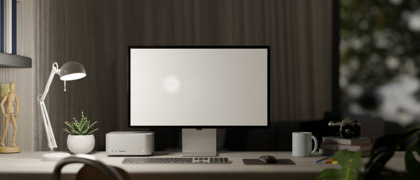 istock Home office workspace in the evening close-up, with computer mockup 1392445456