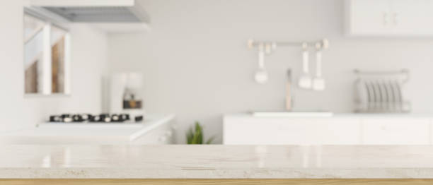 istock Mockup space on luxury granite kitchen tabletop over blurred white elegance kitchen interior 1392445469
