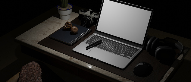 Close-up, Modern dark hipster workspace with open laptop white screen mockup, camera, headphone and stuff on the table. 3d rendering, 3d illustration