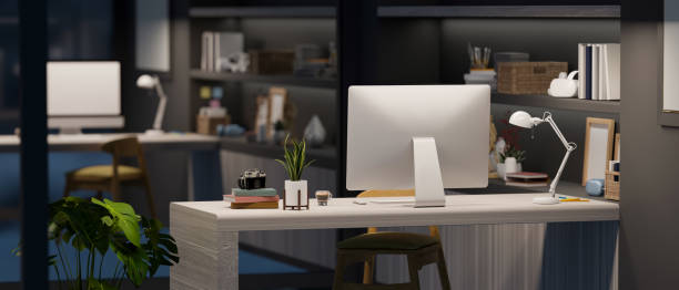istock Office desk workspace at night in modern interior style 1392445516
