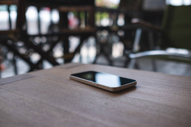 istock A single mobile phone on wooden table 1392447774